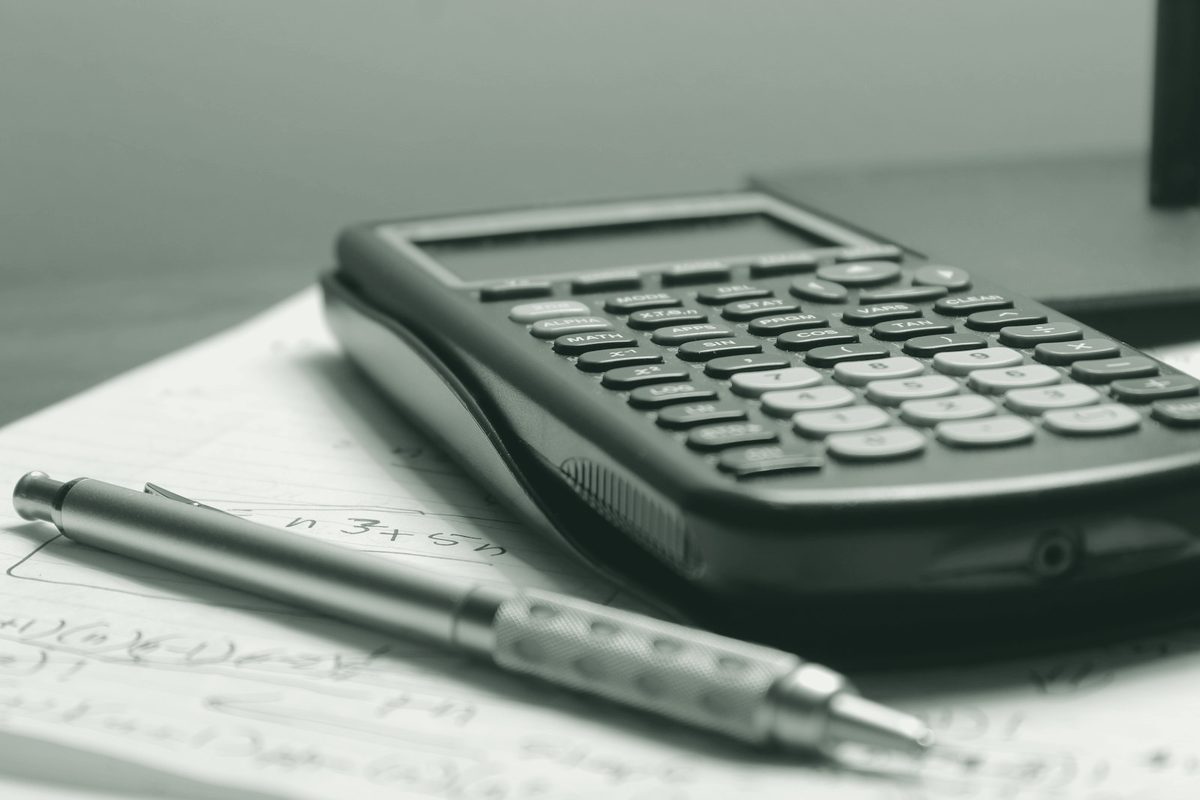 Paper accounts and a calculator on a desk